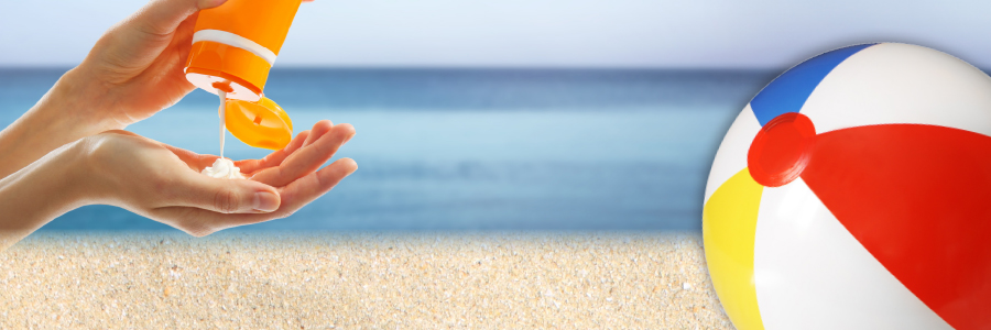 Image of beach scene with person applying sunscreen and a beach ball