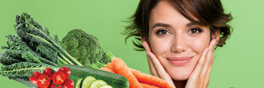 Image of organic vegetables next to a person holding their face