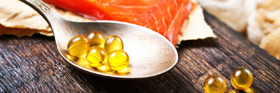 Image of a spoon with vitamin capsules