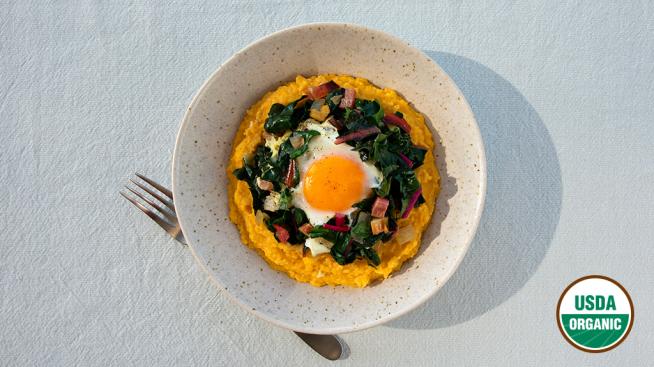Organic Eggs Nestled in Sautéed Chard Served Over Creamy Polenta 
